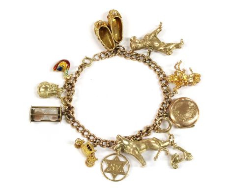 A 9ct gold charm bracelet, a 9ct gold curb link bracelet suspending eleven assorted charms, to include eight charms hallmarke