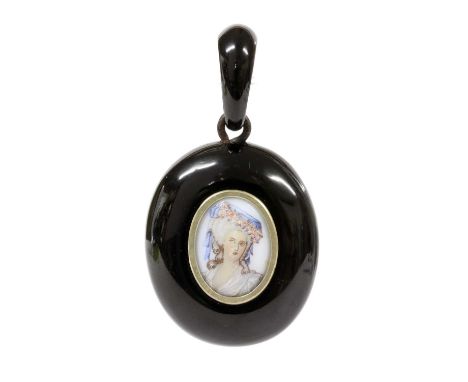 A Victorian carved jet pendant, with a hand painted porcelain plaque to the centre, depicting a lady in 18th century costume,