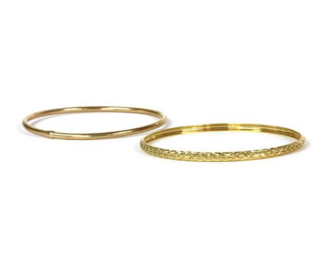 A 9ct gold hollow round section bangle, Sheffield, 64mm internal diameter, together with a 9ct gold concave 'D' section patte
