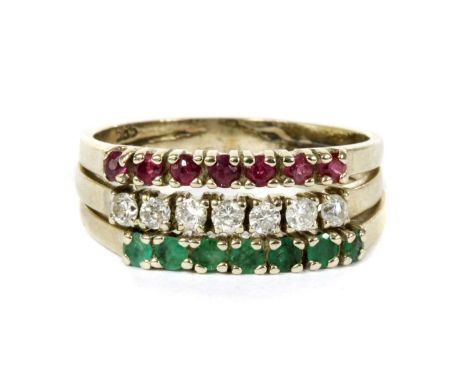 A white gold ruby, diamond and emerald three row ring, a row of circular mixed cut rubies, a row of brilliant cut diamonds, a