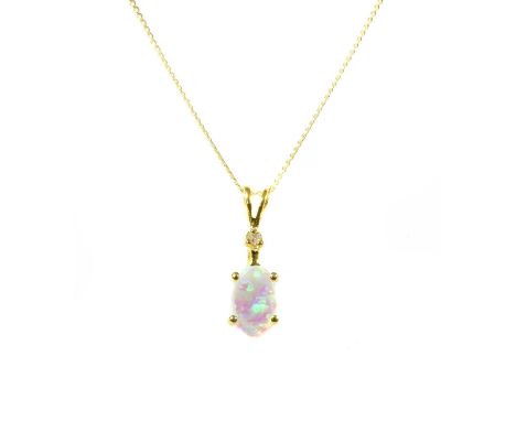 A gold synthetic opal and diamond pendant, an oval cabochon synthetic opal surmounted with an eight cut diamond, both claw se