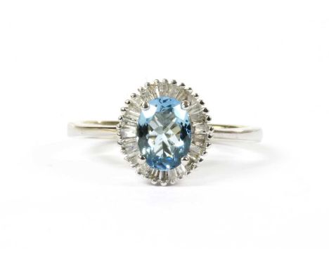 A white gold aquamarine and diamond cluster ring, an oval mixed cut aquamarine, 7.03 x 5.19 x 3.01mm, claw set to surround of