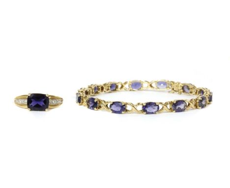 A 9ct gold iolite bracelet, oval mixed cut iolites, approximately 7 x 5mm, claw set to articulated collets and joined by cros