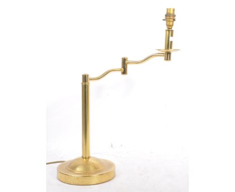 A mid 20th century brass swing arm / extending arm table / reading lamp. Having a round base, with a domed design leading to 