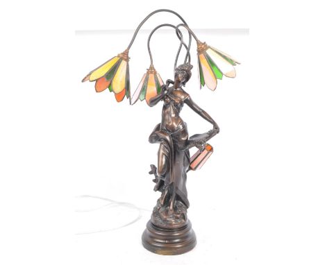 A mid 20th Century French Art Nouveau style glass table lamp light in the manner of Tiffany. Having a brass metal arm with pa