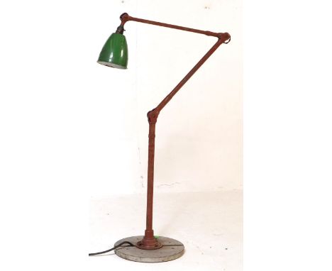 A vintage mid 20th century industrial factory work lamp light. Having a green enamelled conical shade with three hinge suppor