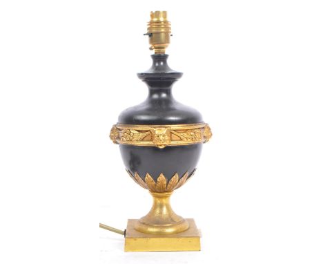 A French Empire style 20th century ebonised & gilt metal desk table lamp light. The lamp having an urn shaped ebonised body w