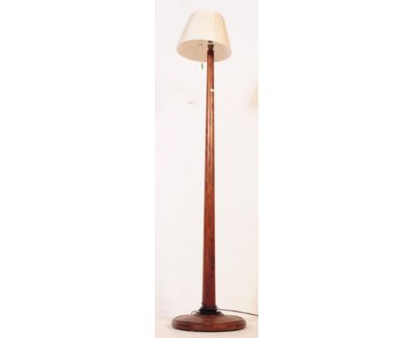 A 19th century Victorian mahogany floor standing standard lamp having a circular base with block, broad turned stem with ligh