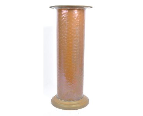A vintage 20th century planished copper umbrella stand. Of circular form with a lipped rim into a cylindrical central column 