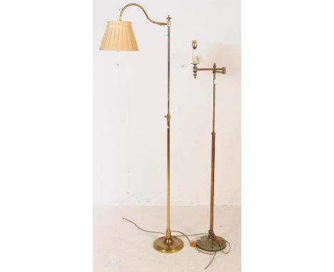 Two early 20th century brass adjustable floor standing standard lamps. The lamps each having round shaped bases, with a long 