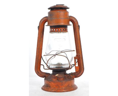 A mid 20th century Chalwyn painted metal miners oil lamp. The lamp of metal construction, with a bulbous glass shade held wit