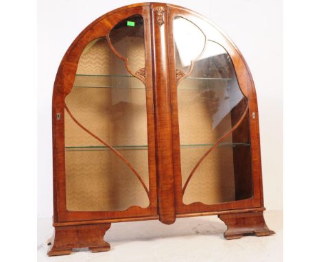 A vintage 1930s Art Deco walnut veneered dome china display cabinet. Twin full length glazed doors with carved decoration to 