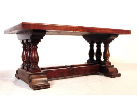 A vintage 20th century hardwood baluster leg coffee table. Of rectangular form with trestle baluster legs united by a trio of