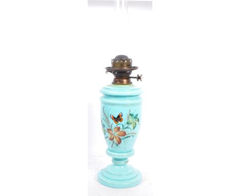 A late Victorian late 19th century opaline glass hand enameled oil lamp light. The lamp having a glass funnel atop over a tur