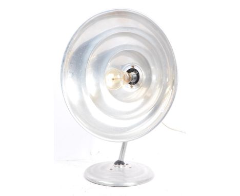 A mid 20th century Estawa chromed metal circular wall lamp. The lamp having an oversized circular metal shade, with a bent ad