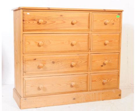 A 20th century country pine large chest of drawers. The chest with upright bank of two drawers, flanked to the right by singl