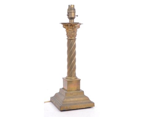 A 1930s brass / gilt metal corinth column table desk lamp. The terraced brass base with push button inset to brass light fitt