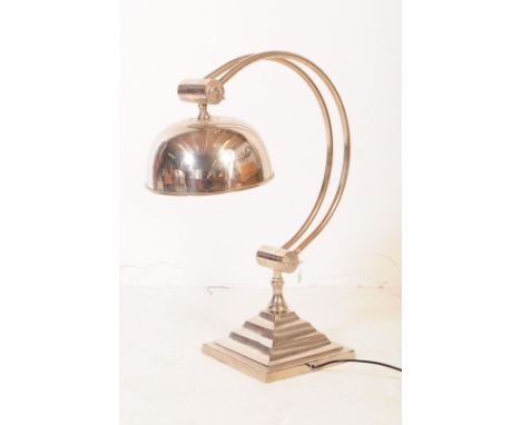 Andrew Martin - A mid 20th century Andrew Martin industrial chromed metal table lamp. The lamp sat on a stepped squared base,