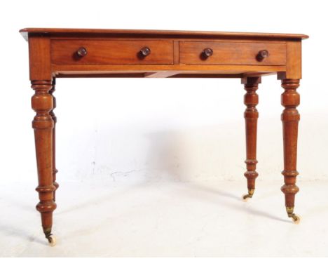 A Victorian 19th century mahogany side / hall writing table. The table with double drawers to side, raised on turned tapering