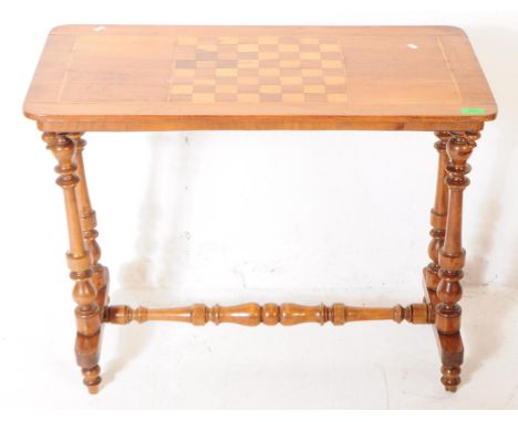 A 19th century Victorian walnut sofa side / games table. The table raised on twin turned supports to each side, beside downwa