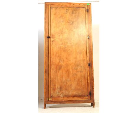 An early 20th century oak wood narrow hall cupboard closet. The cupboard raised on block feet with large door to front, openi
