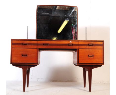 British Modern Design - Mid 20th century teak dressing table. Rectangular form with knee hole to centre with single drawer ab