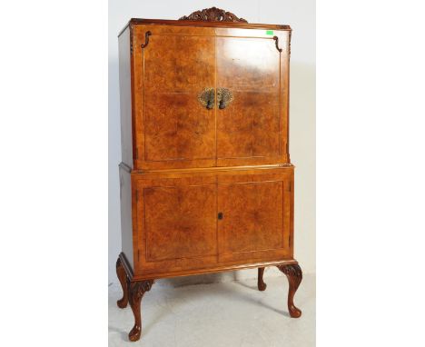 A 20th Century Queen Anne revival&nbsp; manner walnut cocktail bar / drinks cabinet. The cabinet having a double door cabinet