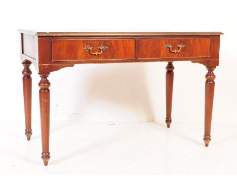 A George III revival mahogany writing table desk. Of rectangular form with two parallel drawers. All supported on turned legs