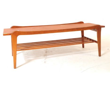 British Modern Design - Vintage mid 20th century teak coffee table. Rectangular form with plank top, outer curved leg detaili