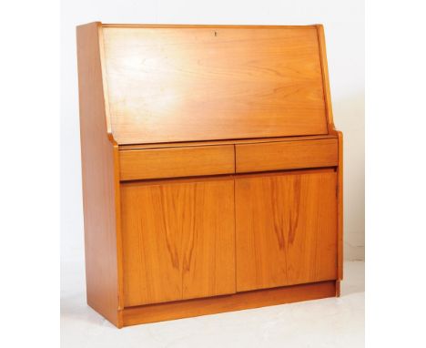 Remploy - A mid 20th century teak wood bureau desk. Of rectangular form with pull down front cabinet door with appointed inte