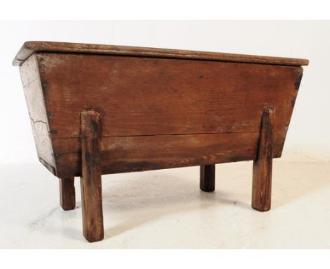 A 19th century French pine dough bin / trough. The trough raised on squared block leg stand, having a slanted side design, wi