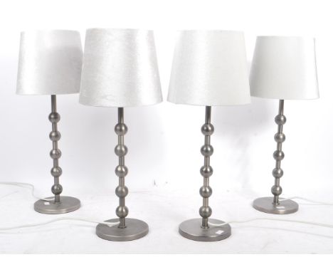 A collection of four contemporary pewter ball side table / desk lamps. Each lamp featuring a central column with a series of 