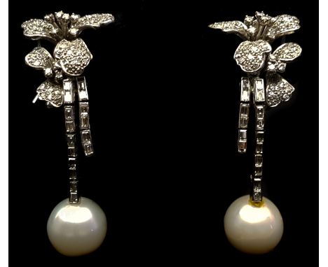 A pair of pearl and diamond drop earrings, the 10mm pearls suspended on baguette cut 'stems' from two trefoil flowers each 4.