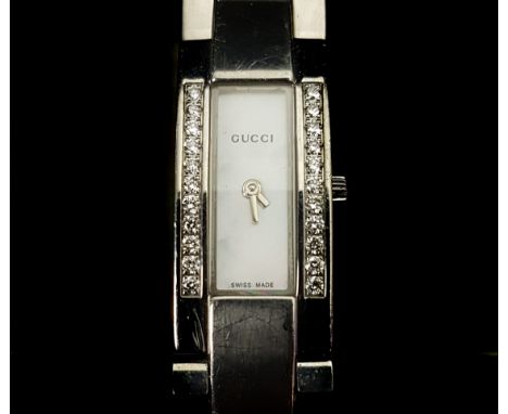 A ladies Gucci wristwatch, rectangular mother of pearl dial, flanked by two rows of round brilliant cut diamonds on stainless