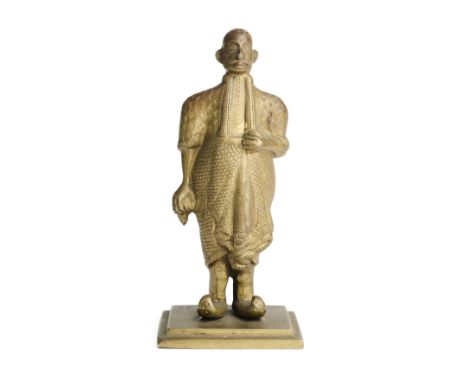 A BRASS FIGURE OF A KANDYAN NOBLEMAN, NEGOMBO, SRI LANKA, CIRCA 1900 wearing pointed shoes and long scarf, on square base, 14