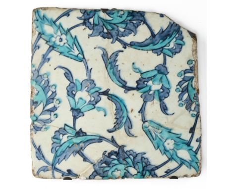 AN IZNIK BLUE AND WHITE TILE, OTTOMAN ANATOLIA, 17TH CENTURY underglaze painted fritware, of square form, with design of scro