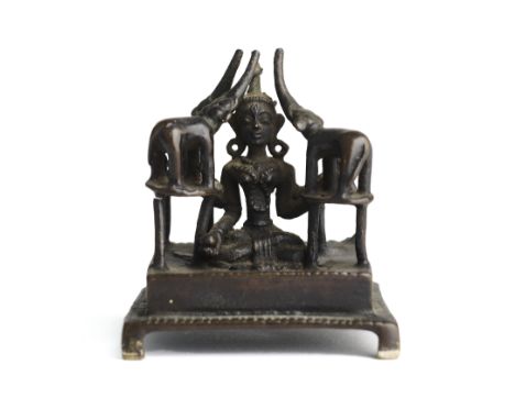 AN UNUSUAL SMALL BRONZE SHRINE DEPICTING GAJALAKSHMI, INDIA, 19TH CENTURY the square base on bracket feet, the four-armed god
