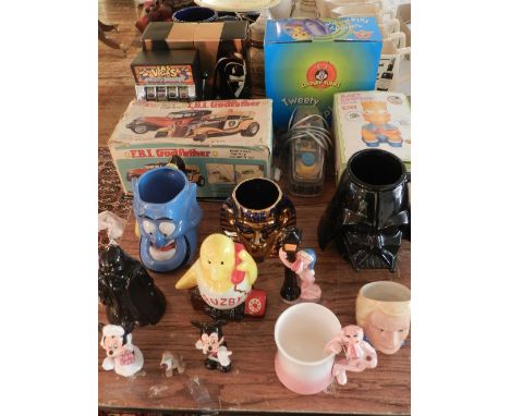 A collection of ceramic children's character mugs and figures, to include a Wade Disney hound and a Pink Panther mug and figu