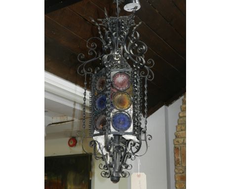 A cast iron and glass ceiling lantern, fashioned with scrolling foliage