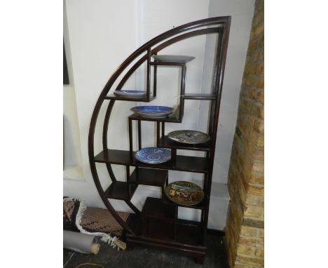 A 1920's oak semi-circular shelf unit, in the Chinese taste. H.70cm W.87cm