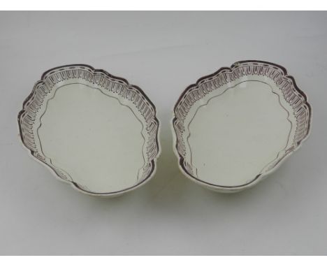 A pair of early 19th century Wedgwood cream ware serving dishes, of lobed lozenge form. painted with egg and darts in a puce 