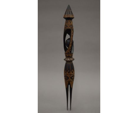 A carved tourist piece cannibal fork. 46 cm long.