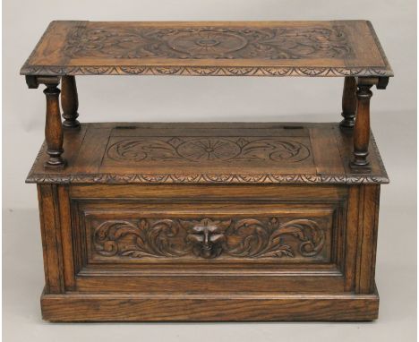 A Victorian carved oak monk's bench. 91 cm wide.