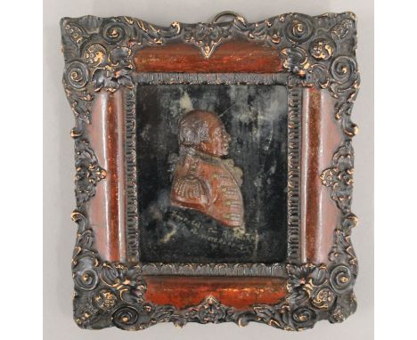 A small 19th century wax portrait of a military officer, framed and glazed. 16 x 17.5 cm.
