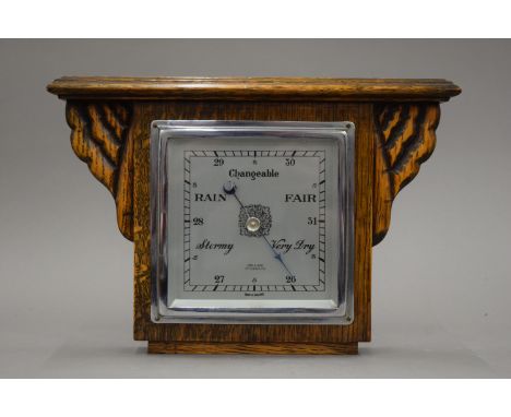 An early 20th century hanging barometer with Art Deco light oak case marked Cox and Sons Great Yarmouth.