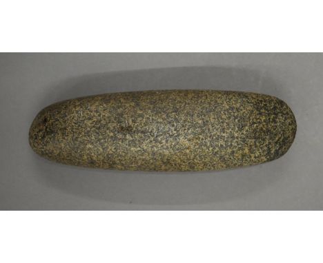 A stone hand axe, possibly Neolithic. 16 cm long.