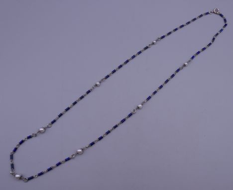 An enamel and seed pearl set silver necklace. Approximately 62 cm long.