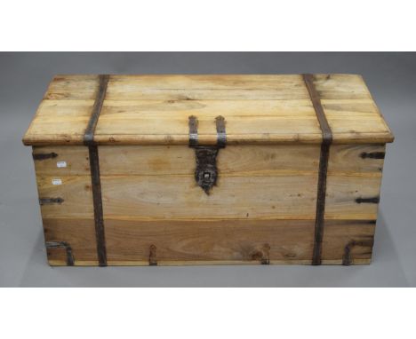 A 19th century striped teak trunk with iron strap work. 100 cm wide.