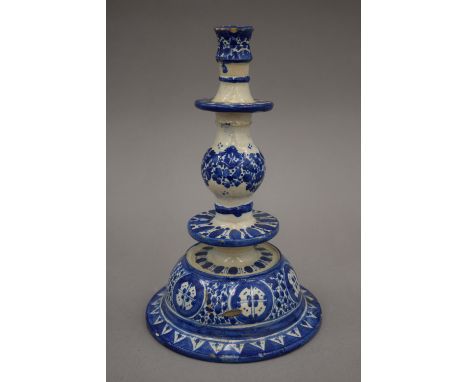 A blue and white tin glaze pottery candlestick. 24 cm high.