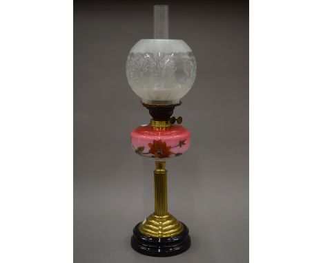 A Victorian oil lamp with etched glass shade. 67 cm high overall.